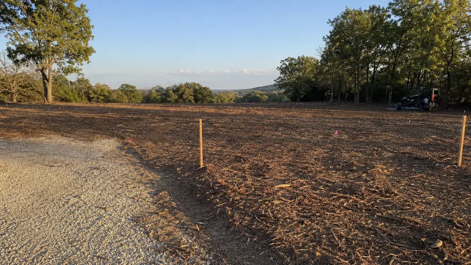 Freshly cleared and mulched building site in Parker County, Texas with survey stakes